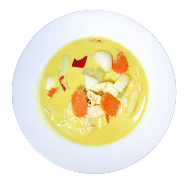 Yellow curry with chicken, potato, onion, carrot and red bell pepper in coconut curry sauce