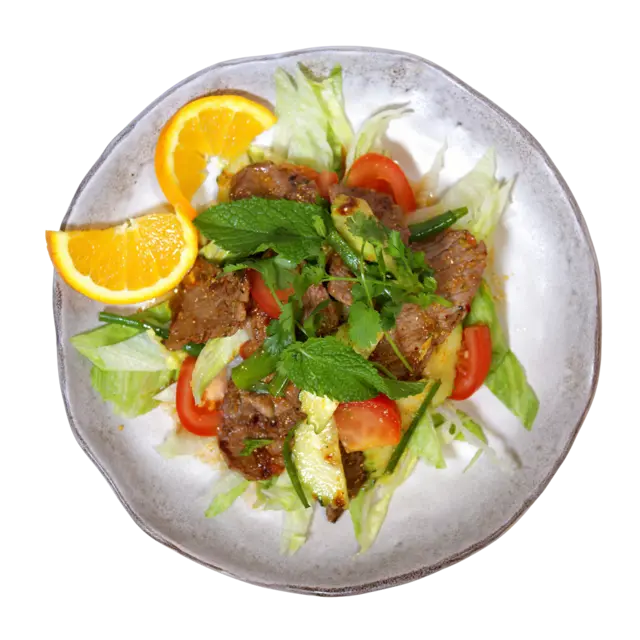 Grilled beef salad with sliced steak, fresh mint, cilantro, tomato, cucumber and crisp lettuce