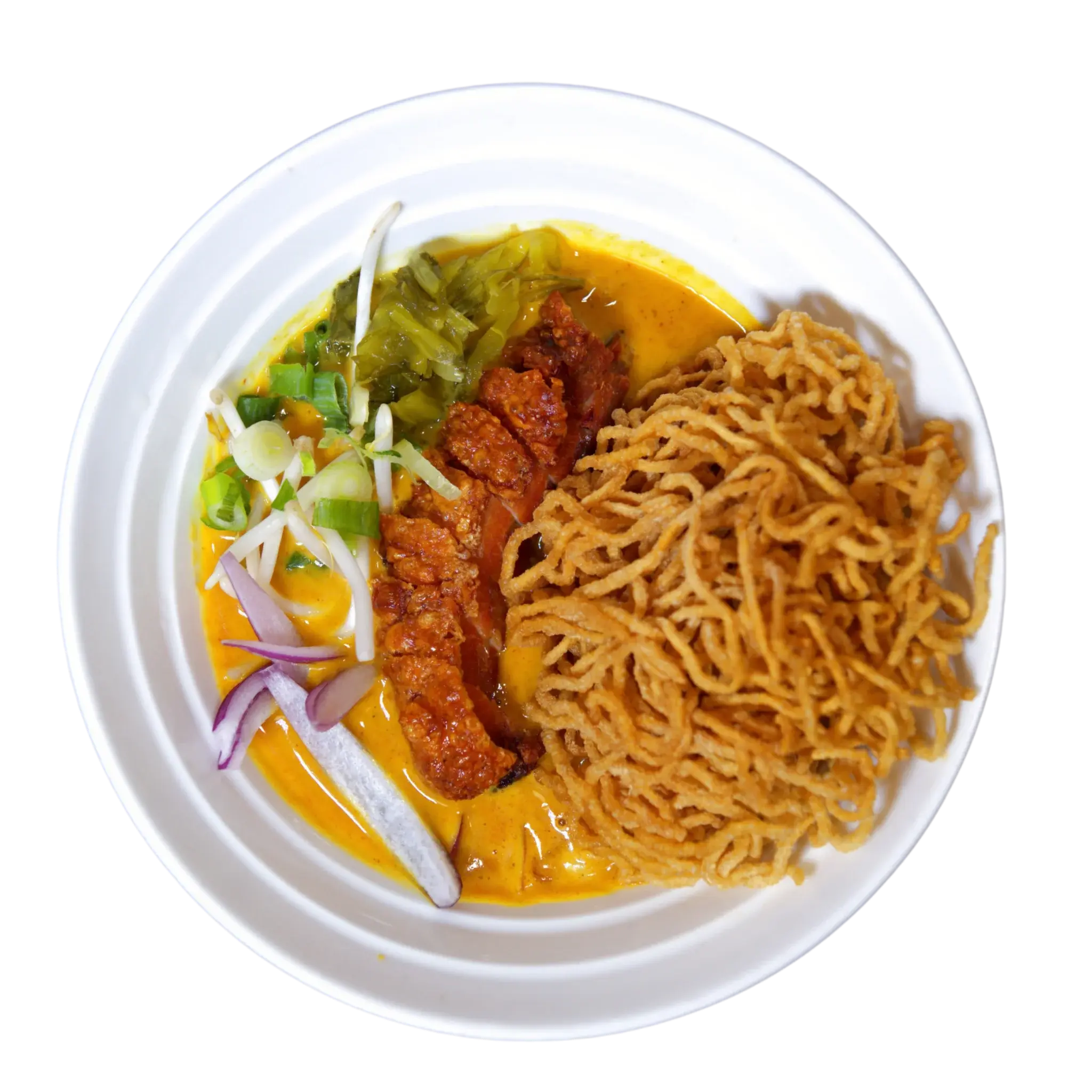 Crispy pork belly Khao Soi in Northern Thai coconut curry broth with fried egg noodles