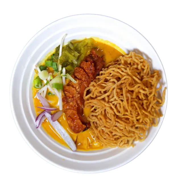 Crispy pork belly Khao Soi — Northern Thai coconut curry broth topped with fried egg noodles, pickled mustard greens and red onion