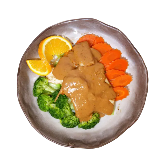 Thai peanut sauce poured over sliced protein with steamed broccoli and carrots