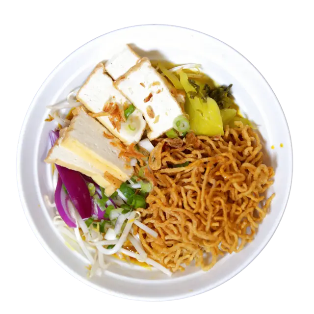 Tofu Khao Soi — fried tofu in Northern Thai curry broth with crispy egg noodles, pickled mustard greens and red onion