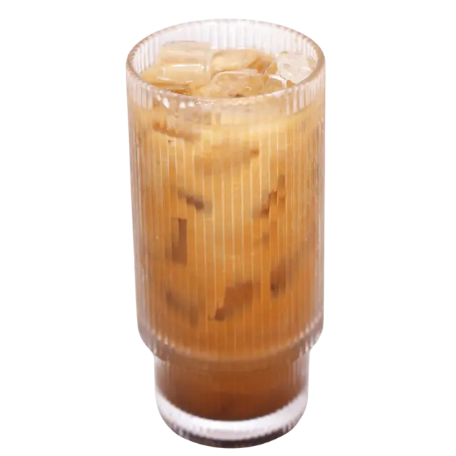 Thai iced coffee served over ice in a fluted glass with milk stirred through