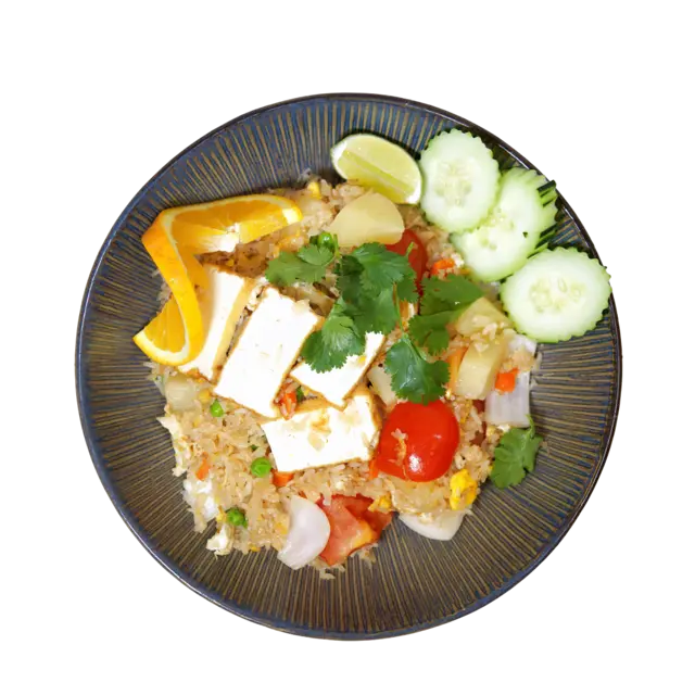 Pineapple fried rice with tofu, peas, carrot, tomato and cucumber